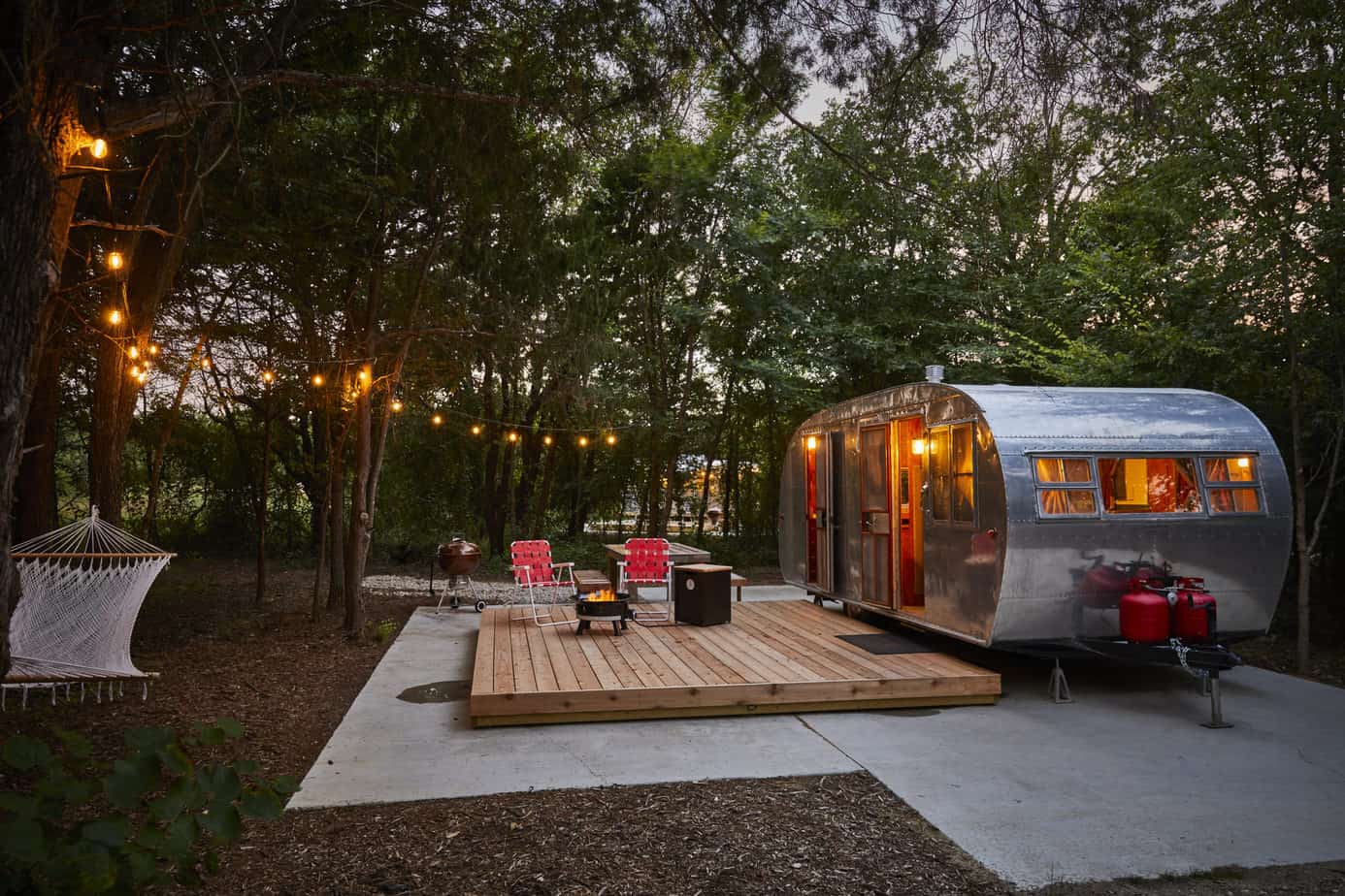 Vintage Airstream trailer at dusk with string lights